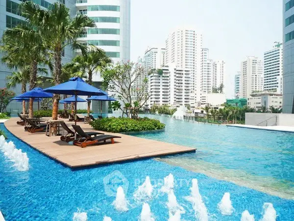 Luxurious rooftop pool with city skyline views and sun loungers, perfect for relaxation and leisure.