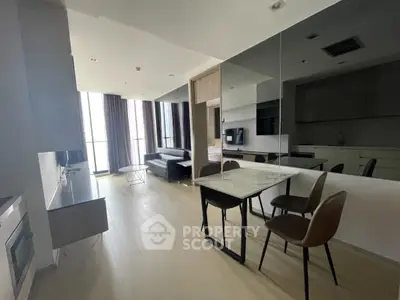 Modern living room with sleek furniture and large windows in a stylish apartment.