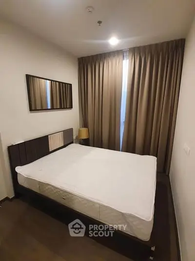 Cozy bedroom with modern decor and ample natural light, perfect for relaxation.