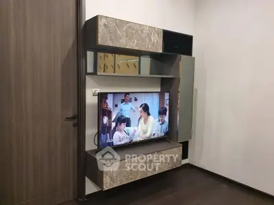Modern living room with stylish TV unit and marble accents