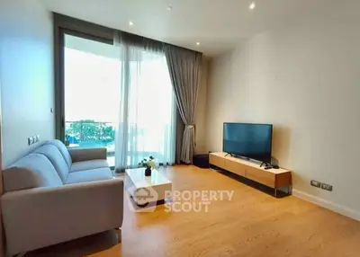 Spacious modern living room with large window and stylish furniture