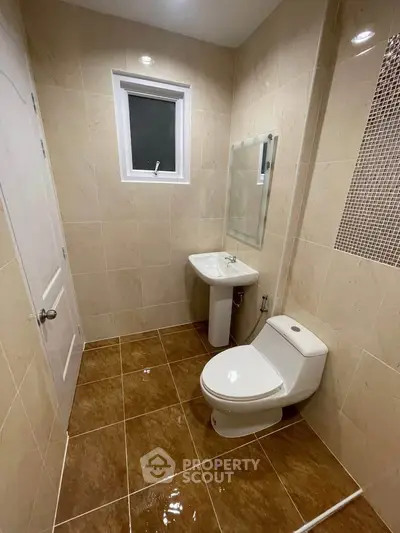 Modern bathroom with beige tiles and sleek fixtures