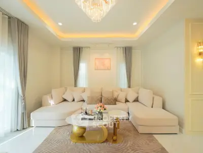 Luxurious living room with elegant chandelier and plush sectional sofa