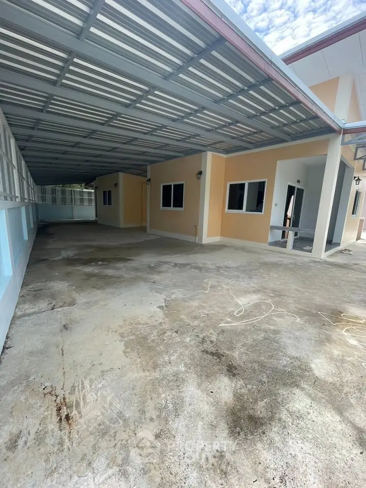 Spacious covered parking area in modern residential property with ample space.