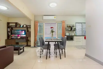 Spacious open-plan living and dining area with modern kitchen and stylish decor.