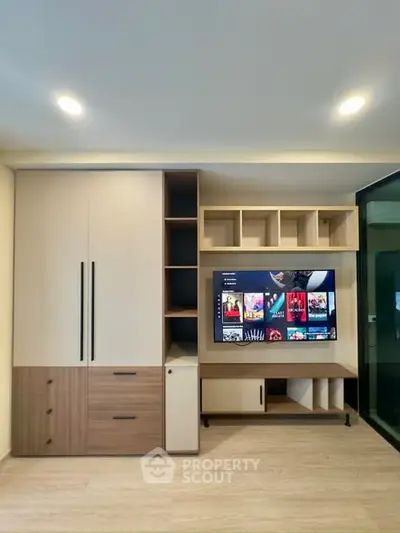 Modern living room with built-in entertainment center and sleek storage solutions.