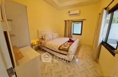 Cozy bedroom with modern decor and air conditioning, perfect for relaxation and comfort.