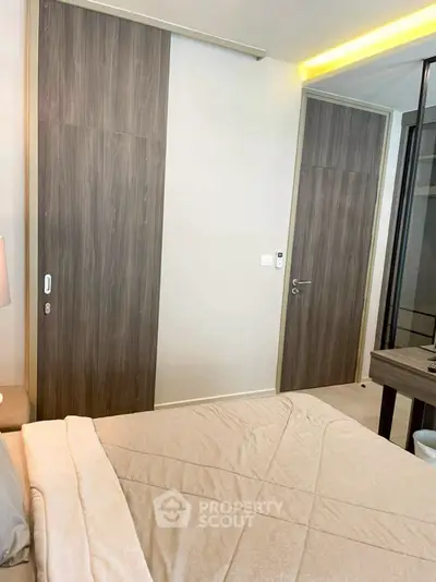 Modern bedroom with sleek wooden sliding doors and cozy bedding