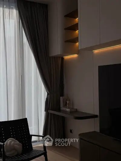 Modern living room with sleek furniture and ambient lighting, featuring floor-to-ceiling windows and elegant decor.