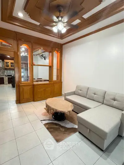 Spacious living room with elegant ceiling design and cozy sectional sofa