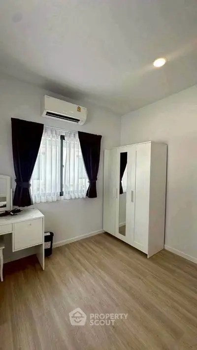 Bright bedroom with air conditioning and modern furniture in a stylish home.