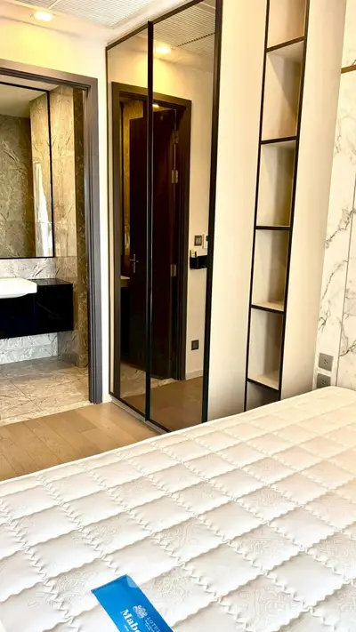 Luxurious bedroom with ensuite bathroom featuring elegant marble accents and modern design.