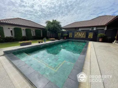 Luxurious private pool in serene villa courtyard with lush greenery and elegant design