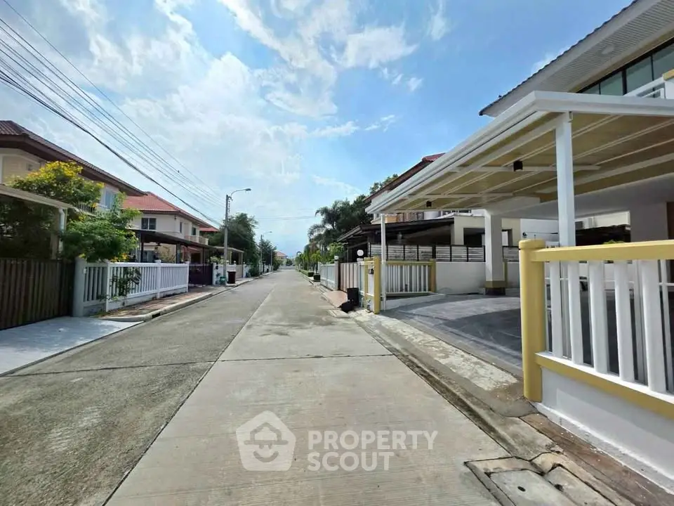 Charming suburban street with modern houses and clear blue sky, perfect for family living.