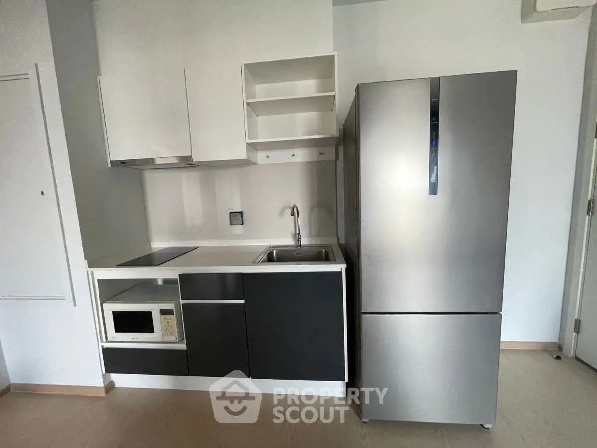 Modern compact kitchen with sleek appliances and minimalist design