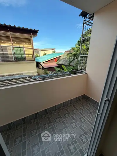 Charming balcony with tiled flooring and scenic neighborhood view, perfect for relaxation and outdoor enjoyment.