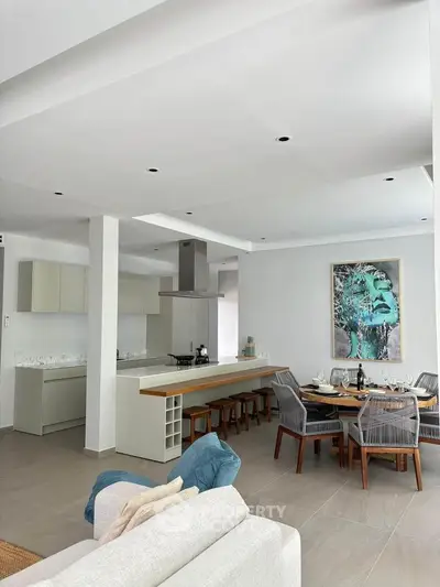 Modern open-plan kitchen and dining area with stylish decor and ample natural light.