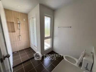 Modern bathroom with walk-in shower and natural light