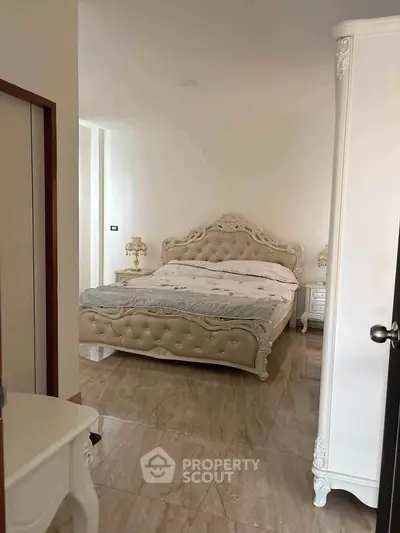 Luxurious bedroom with elegant tufted bed and classic decor