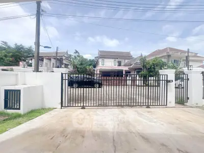 Spacious driveway with secure gate in suburban residential area
