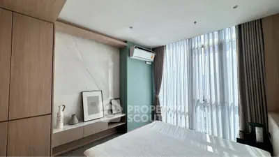 Modern bedroom with large windows and stylish decor