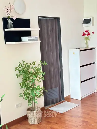 Modern interior with stylish decor, wooden flooring, and elegant shelving in a cozy living space.