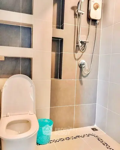 Modern bathroom with sleek shower and toilet in contemporary design.