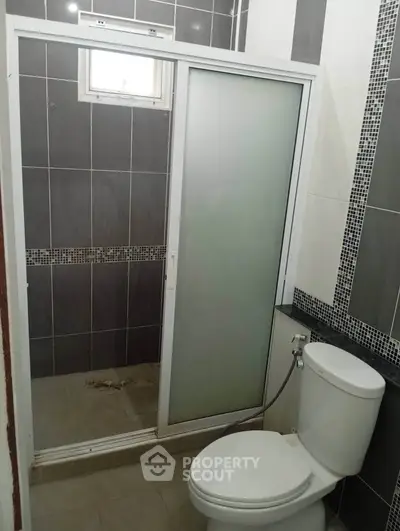 Modern bathroom with sleek shower enclosure and stylish tile design.