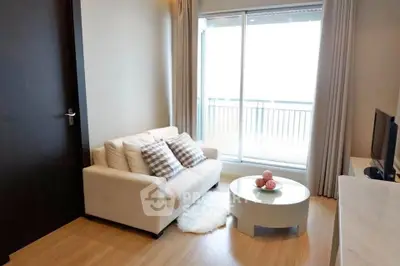 Chic living room with cozy sofa and balcony view in modern apartment