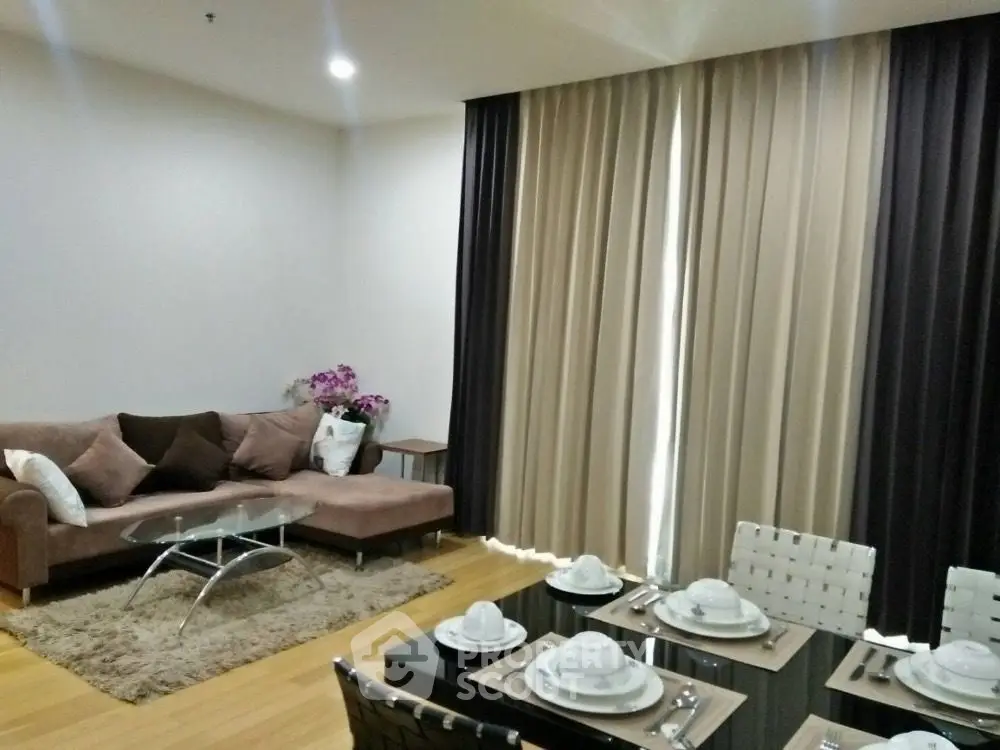 Modern living room with elegant dining setup and cozy seating area