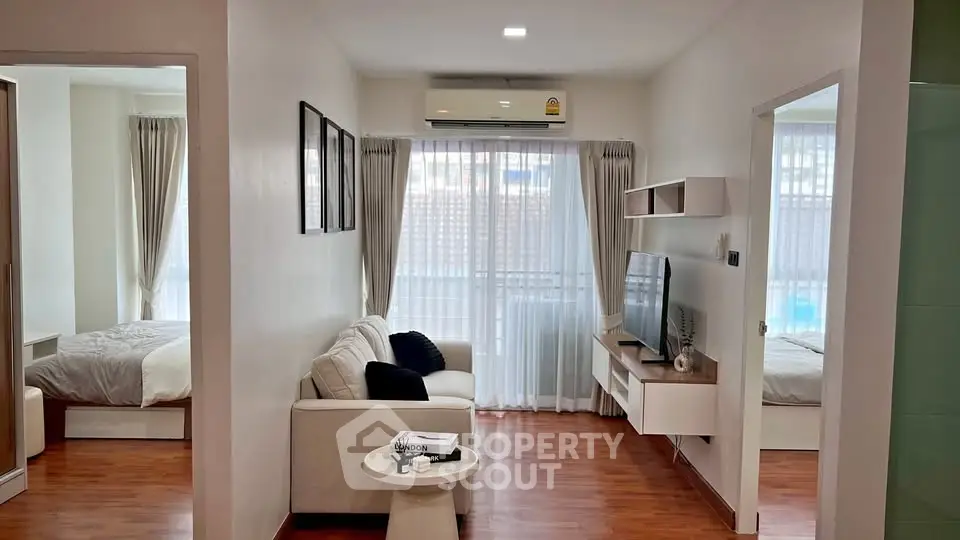 Modern apartment interior with cozy living room and bedroom, featuring stylish decor and natural light.