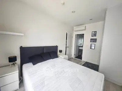 Modern bedroom with sleek design and ensuite bathroom in stylish apartment