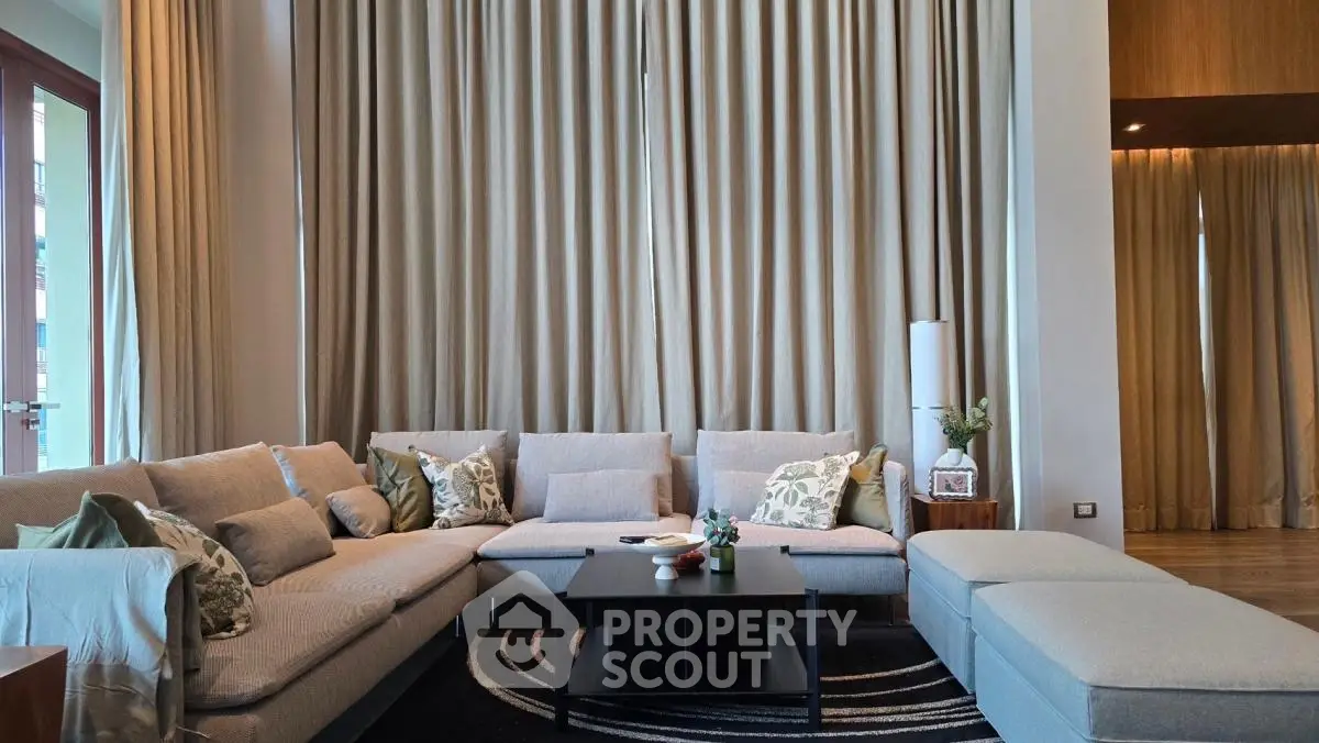 Luxurious living room with elegant decor and large windows, perfect for relaxation and entertaining.