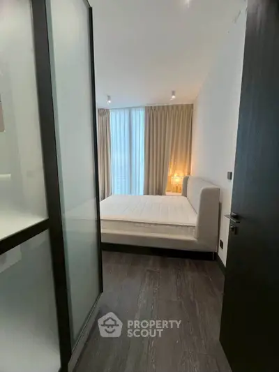 Modern bedroom with floor-to-ceiling windows and elegant decor