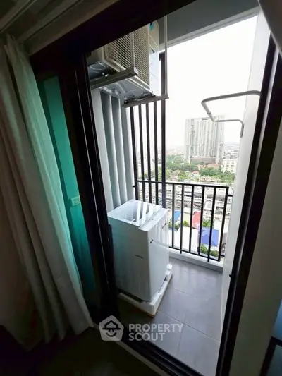 Compact balcony with washing machine and city view in modern apartment
