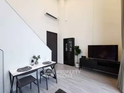 Modern living room with high ceiling and sleek furniture