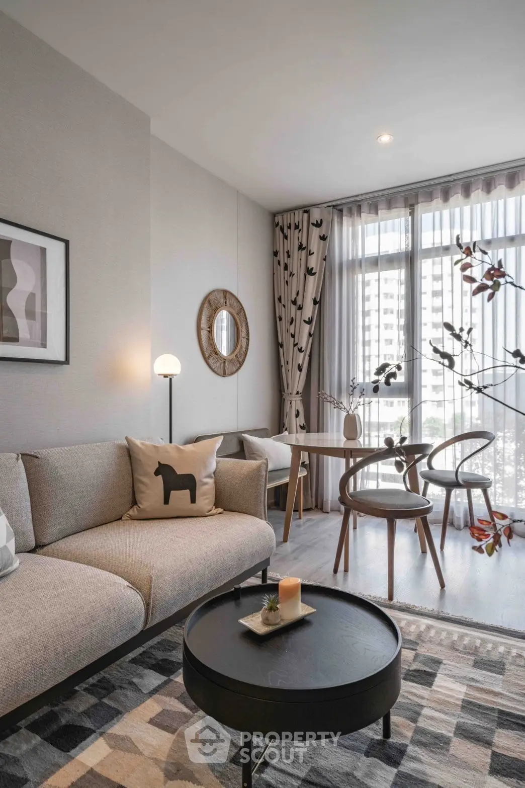 Stylish modern living room with elegant decor and large window view.