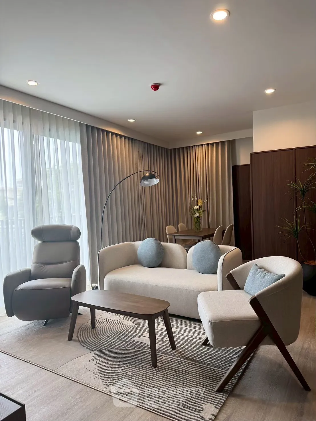 Modern living room with stylish furniture and floor-to-ceiling windows