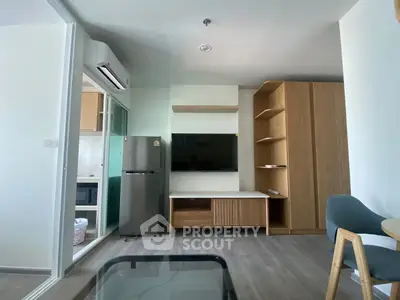 Modern living room with sleek furniture and open kitchen layout in a stylish apartment.