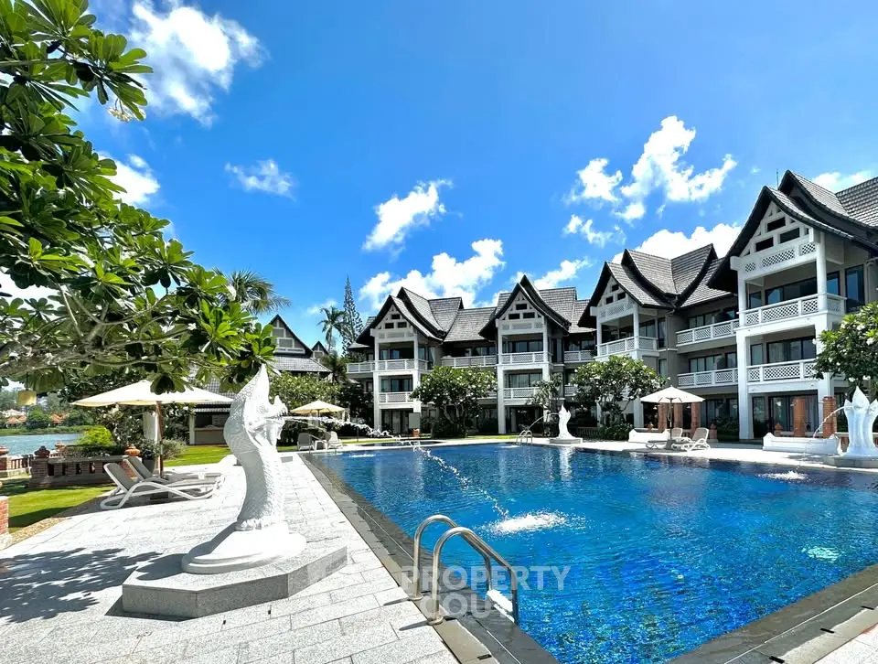 Luxurious resort-style pool with elegant architecture and lush landscaping, perfect for relaxation and leisure.