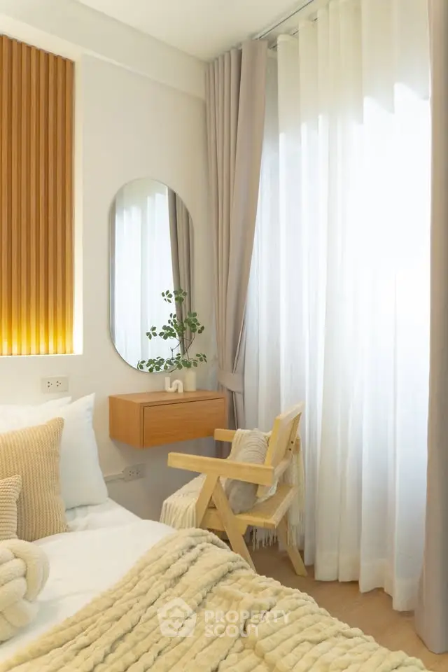 Cozy bedroom with natural light, wooden accents, and elegant decor