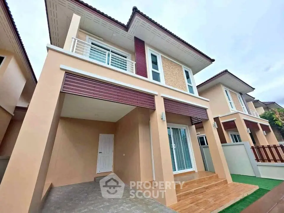 Modern two-story house with stylish facade and balcony