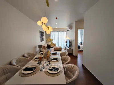 Elegant dining area with modern lighting and cozy seating in a stylish apartment.