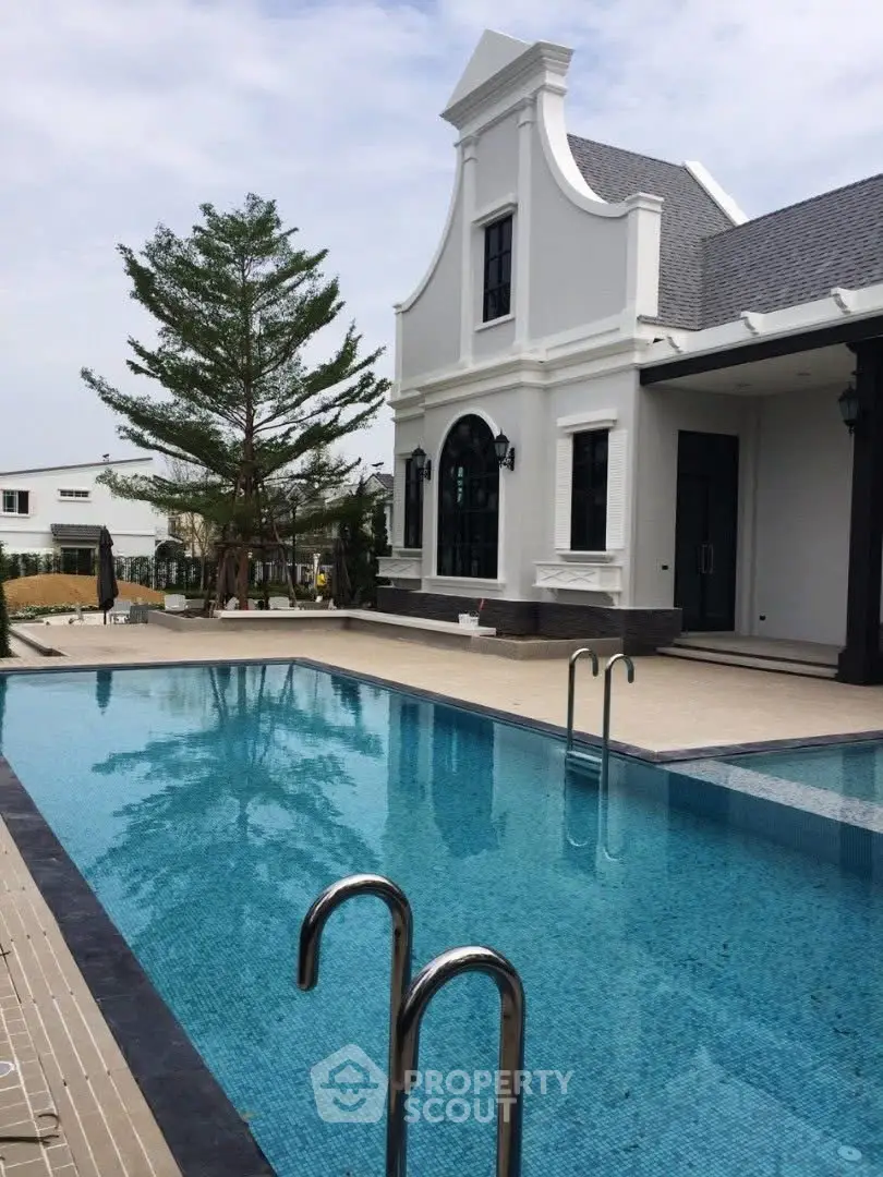 Luxurious villa with elegant architecture and inviting swimming pool, perfect for upscale living.