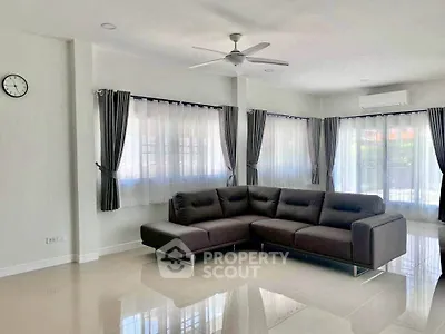 Spacious living room with modern sectional sofa and large windows