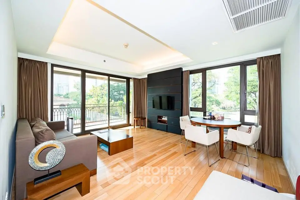 Spacious living room with large windows and elegant decor in a modern apartment.