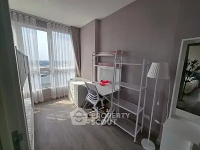 Bright study room with modern white furniture and large window offering city views.