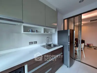 Modern kitchen with sleek cabinetry and stainless steel fridge