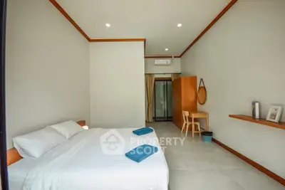 Spacious bedroom with modern decor and ample natural light