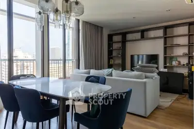 Spacious modern living room with large windows and elegant dining area in urban apartment.